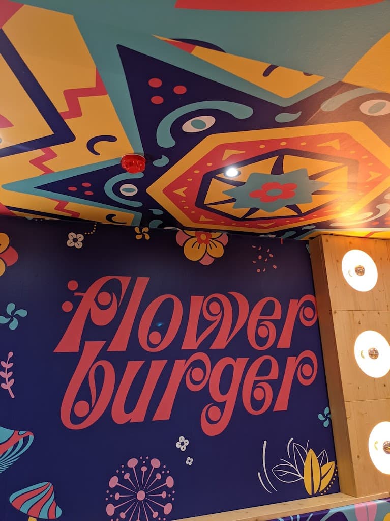 a colourful wall and ceiling of flower burger in brighton